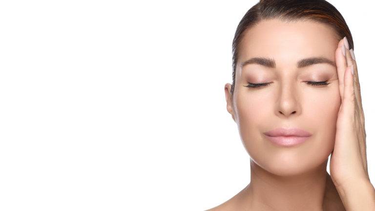 Beauty And Skincare Concept. Gorgeous Brunette Middle Aged Woman Face With Nude Makeup On A Flawless Skin. Panorama Banner With Lateral White Copyspace